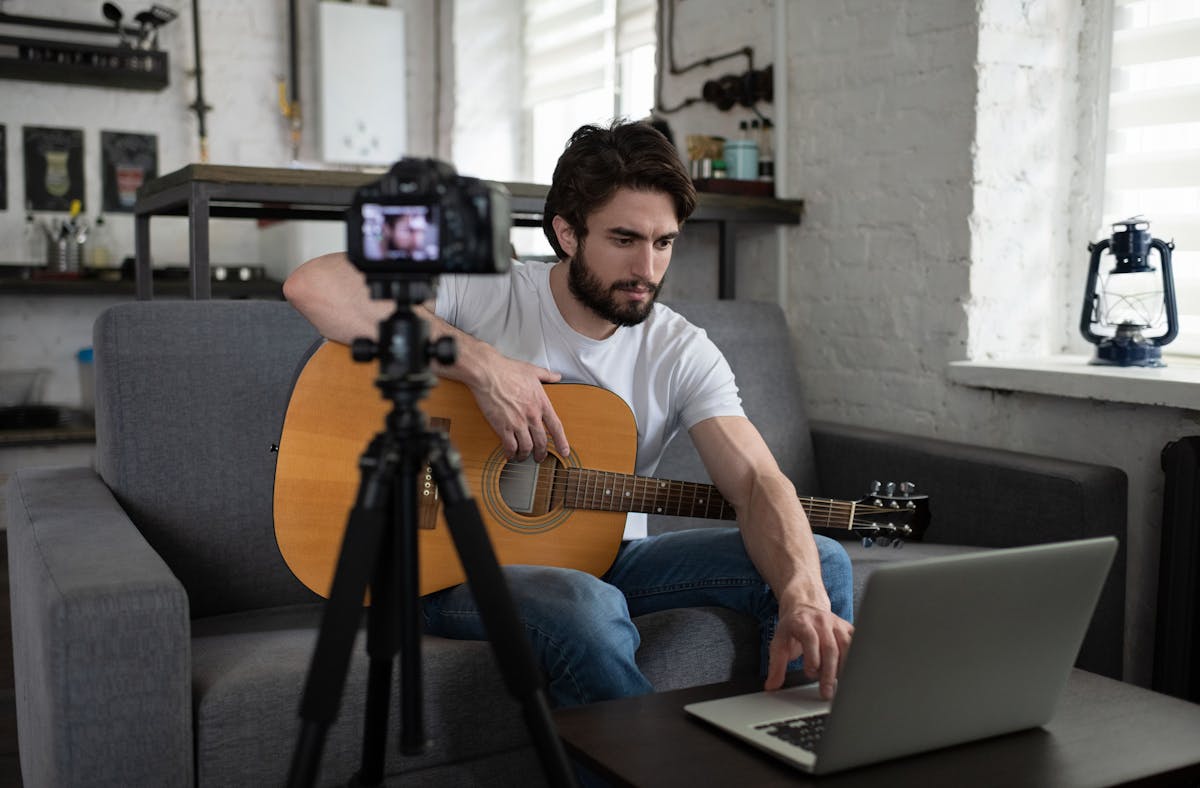 A man recording music for online show or for Spotify. 